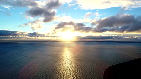 The-flight-above-the-water-on-the-beautiful-sunset-background.-time-lapse