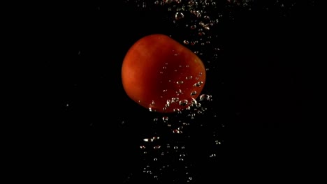 Falling-of-tomato-in-water.-Slow-motion.