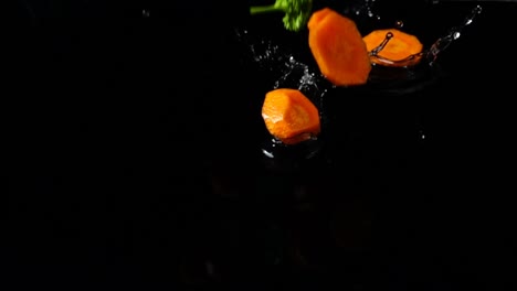 Falling-of-segments-of-carrots,-parsley-and-fennel.-Slow-motion.