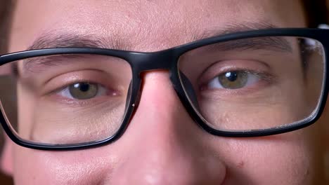 Close-up-eyes-of-caucasian-male-in-glasses-looking-at-camera-and-enjoying