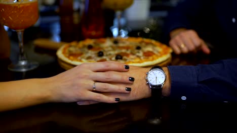 Woman-Strokes-Man`s-Hand-in-Restaurant