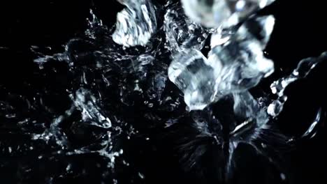 Falling-of-cubes-of-ice-on-a-black-background.-Slow-motion.