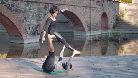 Beautiful-couple-practicing-acro-yoga-in-the-morning