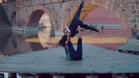 Beautiful-couple-practicing-acro-yoga-in-the-morning