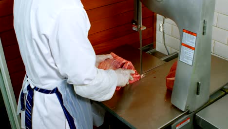 Butcher-cutting-meat-on-meat-cutting-machine-in-shop-4k