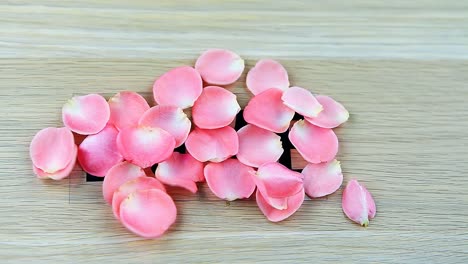 wooden-table-pink-rose-petals-hd-footage