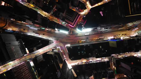 night-time-illuminated-hong-kong-cityscape-downtown-traffic-street-topdown-aerial-panorama-4k