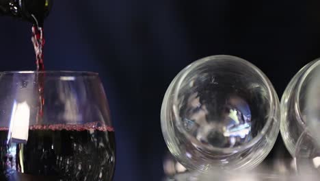 Wine.-Closeup-Of-Red-Wine-Pouring-Into-Glass-From-Bottle