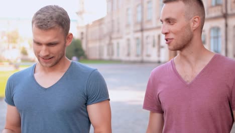 men-laughing-and-speaking-outdoors