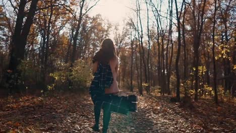 Happy-woman-enjoying-day-in-forest.