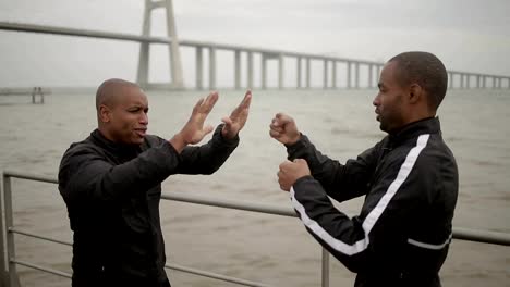 Two-african-american-friends-wearing-sport-clothing-having-fun-outdoor.