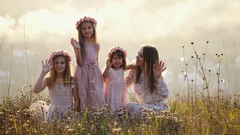 Mother-and-daughters-waving-hands