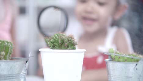 Mother-and-daughter-watering-the-plants-together.