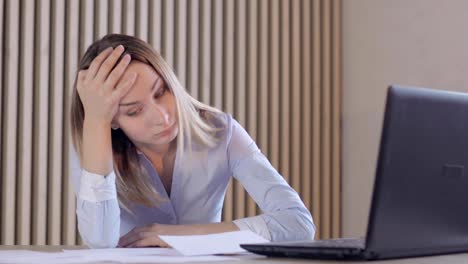 Depressed-woman-checking-her-expenses-in-her-living-room