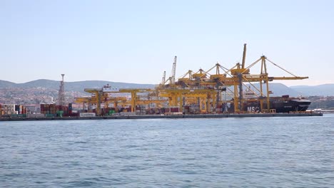 Industrial-Container-Cargo-freight-ship-with-working-crane-bridge-in-shipyard