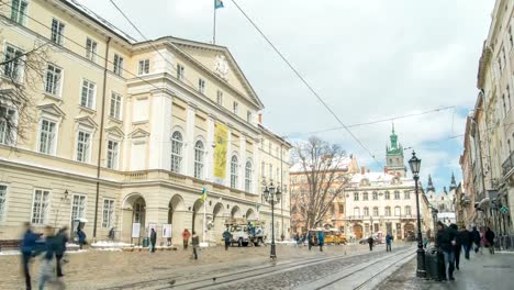 LVOV,-UKRAINE---Winter-2018-Timelapse:-Center-of-old-city-Lviv,-Ukraine.-Time-lapse-of-moving-people-through-the-Market-Square-(Ploshcha-Rynok).-Clouds-are-moving-quickly.-Last-day-of-winter.