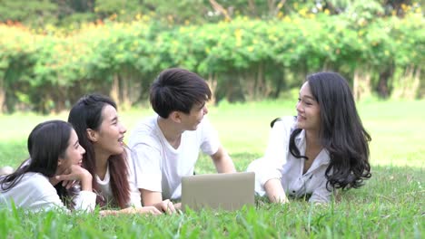 Students-making-group-reports-to-send-instructors.-People-meeting-team-and-using-laptop-computer-in-the-park-outdoors.-Concept-of-education,-together,-teamwork,-learning,-knowledge-and-research.