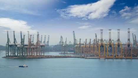 4K.-Singapore-shipping-port-with-cargo-ship-sailing-slowly-on-the-sea-and-many-container-and-yellow-cranes-in-background