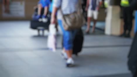 Blurred-background-with-travelers-pulling-suitcase-from-airport-terminal-on-Koh-Samui-in-slow-motion.-1920x1080