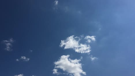 White-cloud-disappear-in-the-hot-sun-on-blue-sky.-Cumulus-clouds-form-against-a-brilliant-blue-sky.-Time-lapse-motion-clouds-blue-sky-background.