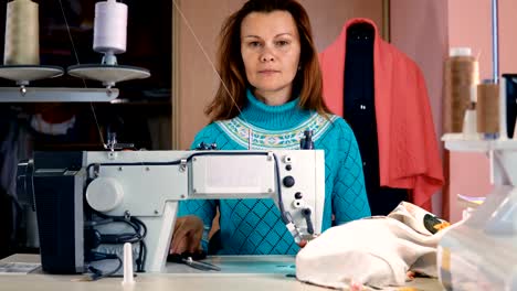 Woman-seamstress-working-in-sewing-studio.