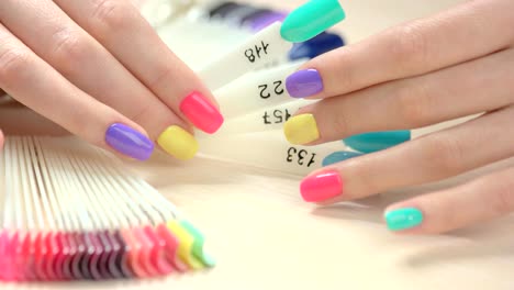 Set-of-multicolored-nail-in-female-hands.