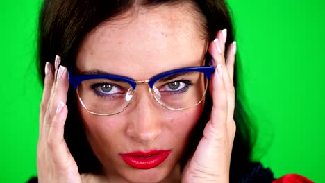 green-background,-chromeakey.-portrait-of-a-sexy-brunette-woman-with-red-lips,-in-stylish-glasses,-spectacles,-eroticly,-playfully-moves,-looking-sexually-at-camera,-posing-in-studio
