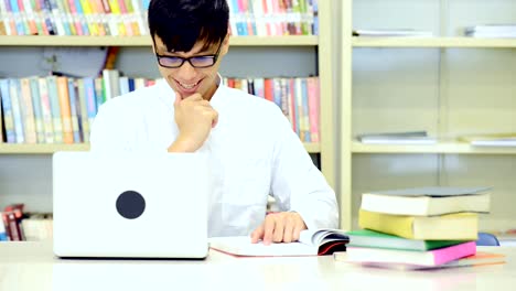 Study-hard-in-library.-Young-Chinese-boy-study-hard-at-library.