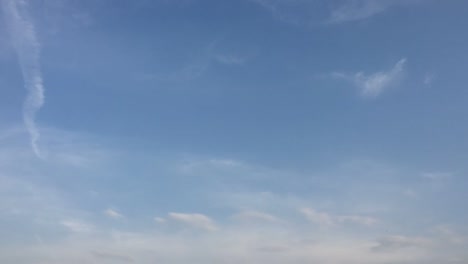 White-clouds-disappear-in-the-hot-sun-on-blue-sky.-Loop-features-time-lapse-motion-clouds-backed-by-a-beautiful-blue-sky.-Time-lapse-motion-clouds-blue-sky-background-and-sun.