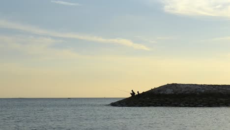 Fisherman-on-Dyke-in-Sunset