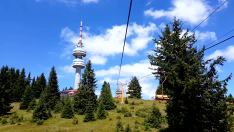 Empty-chair-lift-ascending-in-Pamporovo-winter-mountain-ski-resort-in-Bulgaria-during-summer.