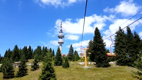 Empty-chair-lift-ascending-in-Pamporovo-winter-mountain-ski-resort-in-Bulgaria-during-summer.