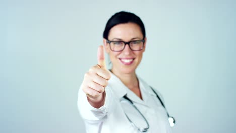 Portrait-of-a-female-doctor-with-white-coat-and-stethoscope-smiling-looking-into-camera-on-white-background.