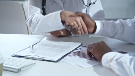 Doctors-Studying-Contract-and-Shaking-Hands