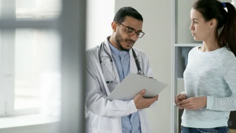 Doctor-Discussing-Medical-Documents-with-Colleague