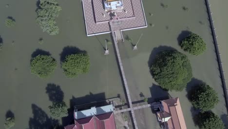 Aerial-overhead-view-of-a-pagoda-is-surrounded-by-floodwaters