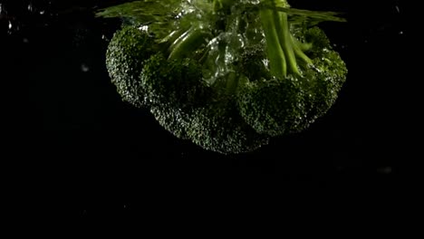 Falling-of-cabbage-of-broccoli-in-water.-Slow-motion.