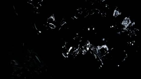 Falling-of-cubes-of-ice-on-a-black-background.-Slow-motion.