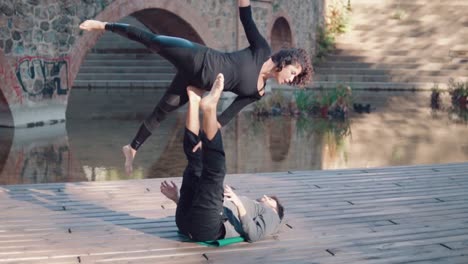 Beautiful-couple-practicing-acro-yoga-in-the-morning