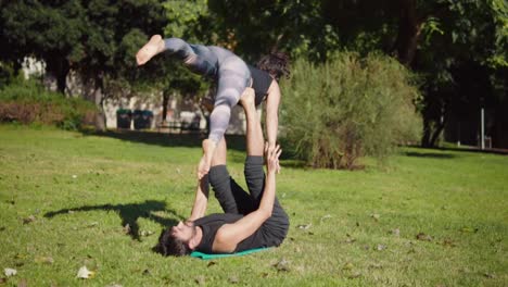 Beautiful-couple-practicing-acro-yoga-in-the-morning