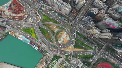 downtown-bay-traffic-road-junction-construction-victoria-harbour-aerial-topdown-panorama-4k-hong-kong