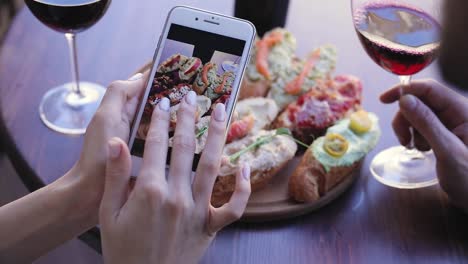 Food-And-Drink-Photo.-Woman-Looking-At-Pictures-On-Phone-Screen