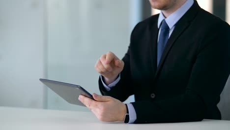 businessman-working-with-tablet-pc-and-something-imaginary