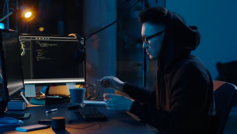 hacker-in-hoodie-using-computers-for-cyber-attack