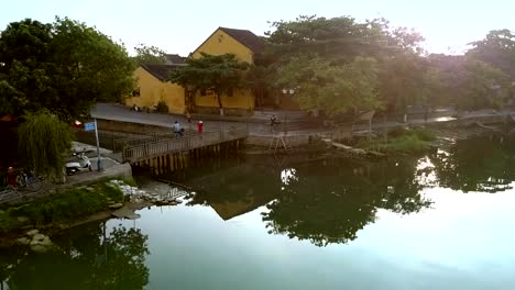 reflejos-de-árboles-ondulan-en-el-agua-cerca-del-puente