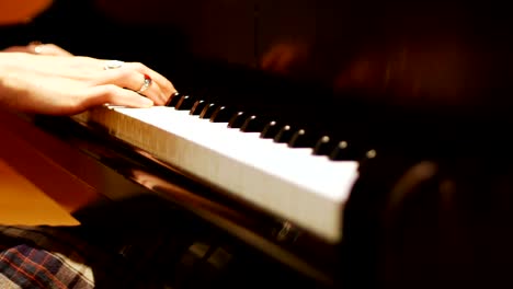 Close-up-of-woman-playing-a-piano