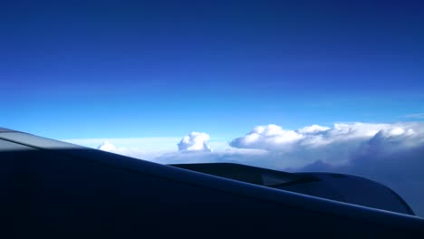 Airplane-window-view-of-clouds-from-passenger-seat