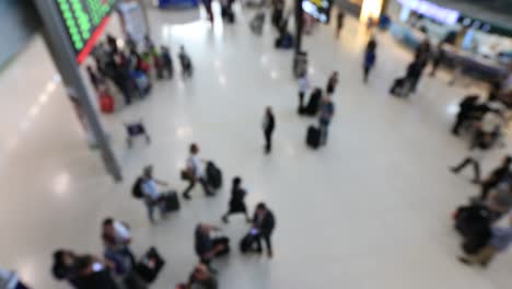 Top-view-of-abstract-blur-airport-terminal-with-commuter-crowd-of-people-and-passenger-walking-when-track-arriving-or-departing-flights,-Blurred-busy-Airport-Terminal-footage-concept.-Full-HD1920x1080