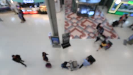 Top-view-of-abstract-blur-airport-terminal-with-commuter-crowd-of-people-and-passenger-walking-when-track-arriving-or-departing-flights,-Blurred-busy-Airport-Terminal-footage-concept.-Full-HD1920x1080