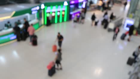 Top-view-of-abstract-blur-airport-terminal-with-commuter-crowd-of-people-and-passenger-walking-when-track-arriving-or-departing-flights,-Blurred-busy-Airport-Terminal-footage-concept.-Full-HD1920x1080